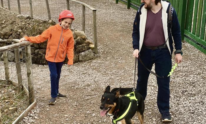 A man, child and a dog walking the surface paths.